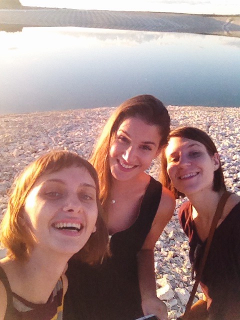 three girls friends near a lake
